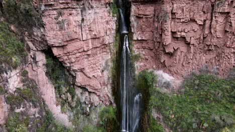 aerial of the spectacular perolniyoc waterfall in urubamba, sacred valley, cusco, peru. drone crane and tilt up
