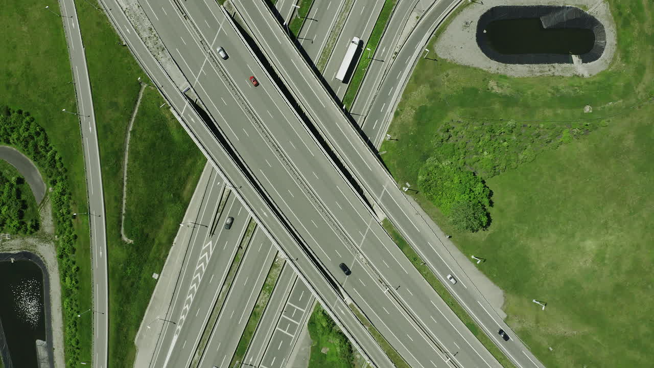 Drone aerial of Truck driving through motorway with green forest lake and mountains alps in the background summer 7
