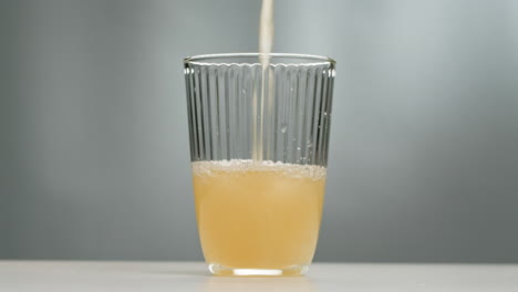 orange or white wine bottle and glass, spanish french apple cider pouring, pouring of ecological natural wine.