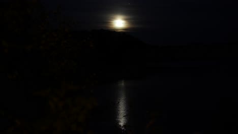 bright moon rising over hills in norway