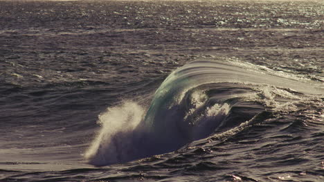 tightly curled wave turns over on itself, strong foam presence and steep barrel collapse