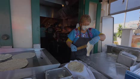 older mexican lady making fresh tortilla's