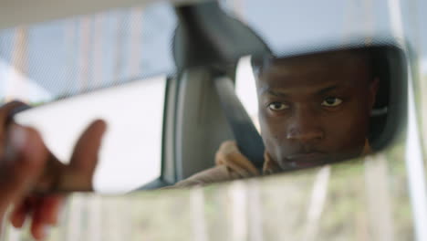 man adjusting rear mirror