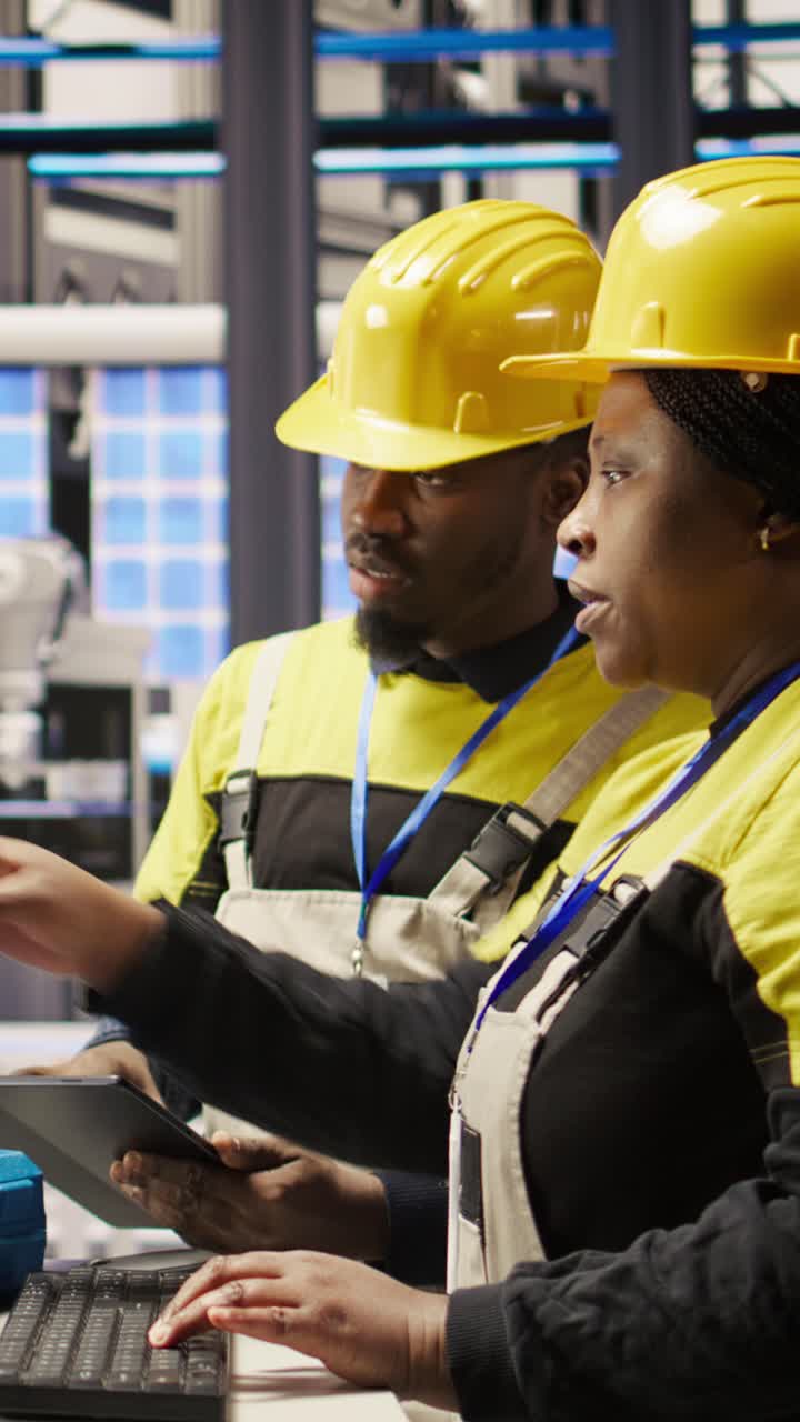 Vertical video Smart factory manager overseeing work done by engineer calibrating machinery