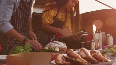 young couple cooking together in food truck