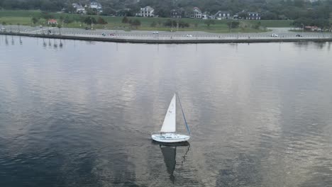 yacht cruising on a tranquil lake near new orleans, louisiana, usa - aerial drone shot