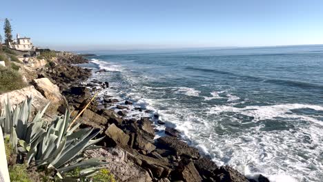 cascais beach with pebble coast washed by sea waves