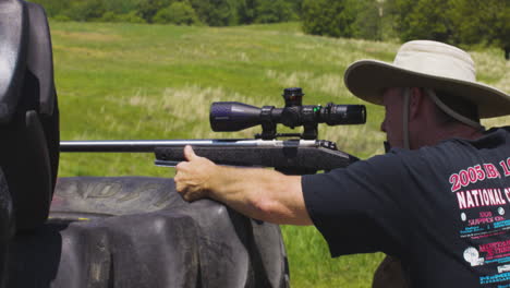 marksman aiming and firing rifle at the firing range