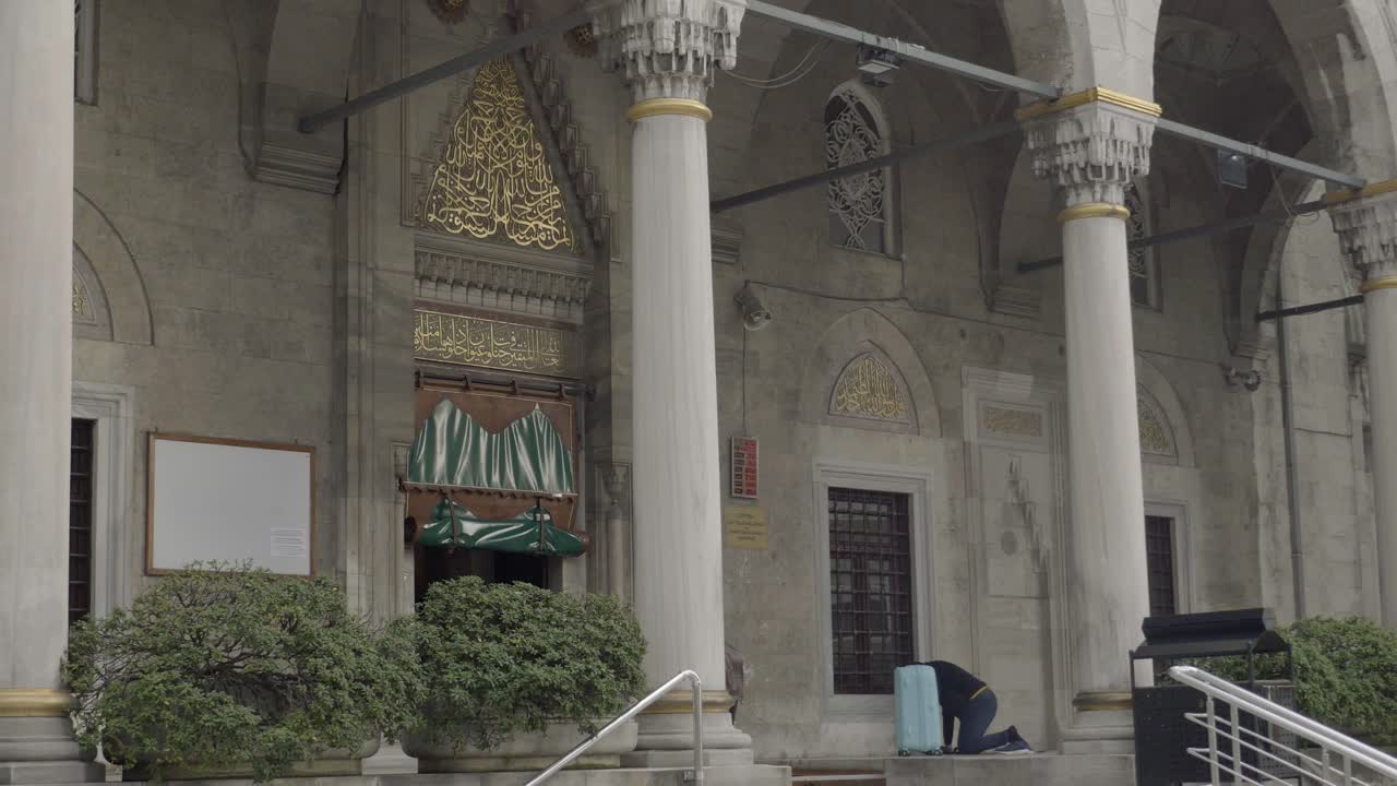 Exterior View of a Mosque with a Person Praying