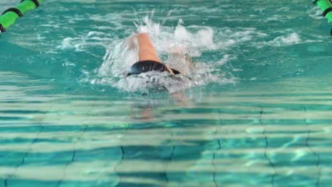 fit swimmer doing the front stroke in the swimming pool