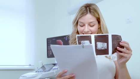 woman reviewing ultrasound images at doctor's office.
