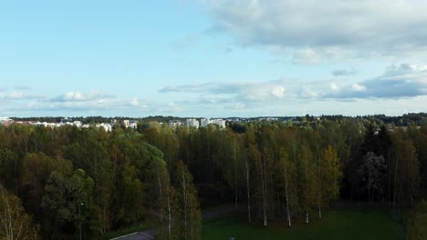 Boom-up-revealing-the-Finnish-town-of-Järvenpää-on-the-shores-of-Lake-Tuusula,-mysterious-cinematic-drone-scene