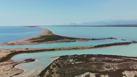 aerial view of serene coastal landscape with clear blue waters and sandy shores