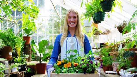 Portrait-of-beautiful-woman-carrying-flower-plant