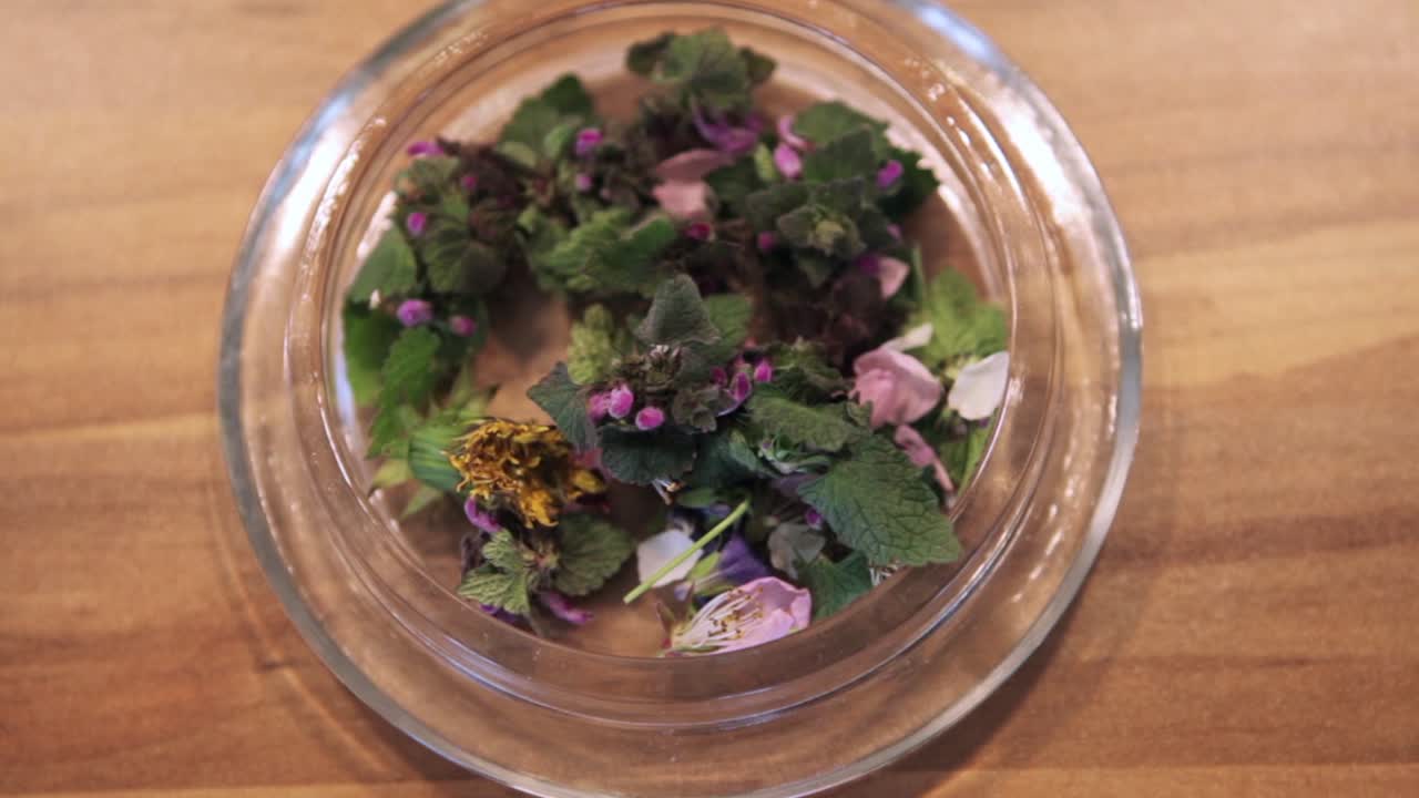 Close-up and zoom in of a dish featuring edible petals and mint