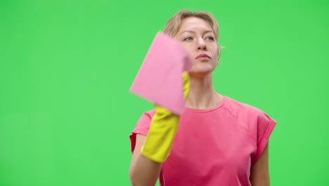 woman cleaning with a pink cloth and yellow gloves