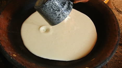 food shot of some homemade traditional moroccan baghrer in clay fryer , pancakes baghrir or crapes with 1000 holes