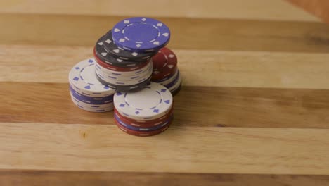 static close up of playing cards thrown down on stack of poker chips