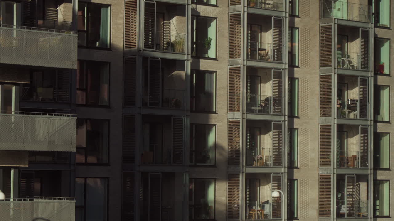 Modern apartment building facade with balconies. Captures urban living atmosphere. Suitable for real estate or city lifestyle promotions.