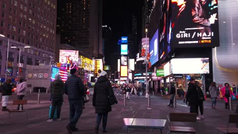 times square at night with people and billboards