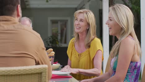 senior woman talking while having lunch outdoors