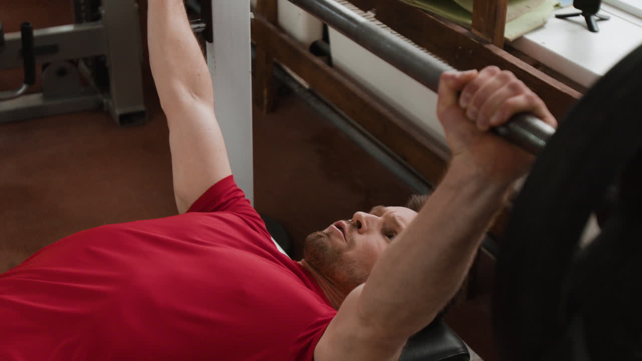 Man Doing Bench Press Workout in a Gym