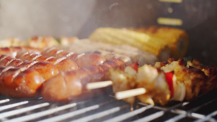 Sausages corncobs and kebabs grilling on a BBQ