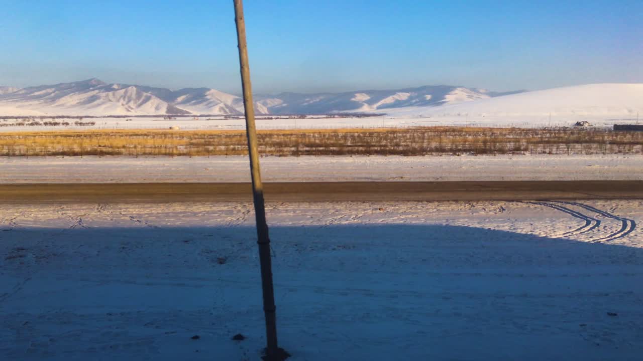 Rural Mongolia Farms During Winter. POV Establishing Shot From Moving Train