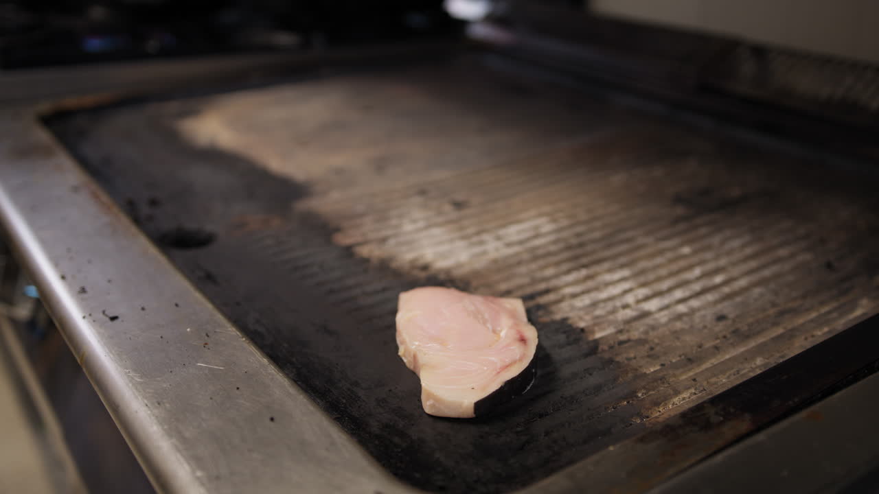 Chef Putting A Slice Of Swordfish On Top Of The Grill