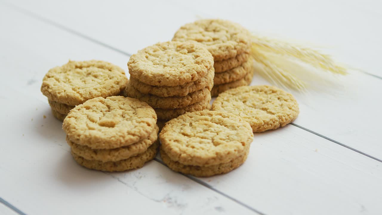 Healthy oatmeal cookies on white wood background  Side view 