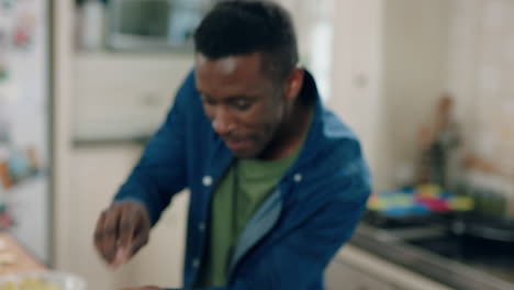 happy african american man dancing in kitchen having fun dance celebration enjoying weekend at home