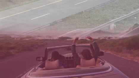 Animation-of-road-over-biracial-couple-in-car-road-trip
