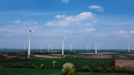 AERIAL---Wind-turbines-in-a-wind-energy-farm-in-Austria,-wide-shot-right