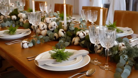 elegant dining table setting with cotton and eucalyptus centerpiece
