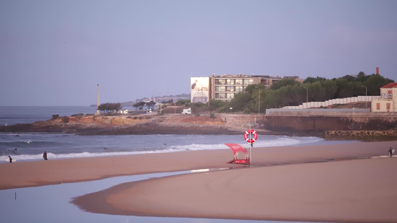 Beautiful Sunset at the Beach with Surfers