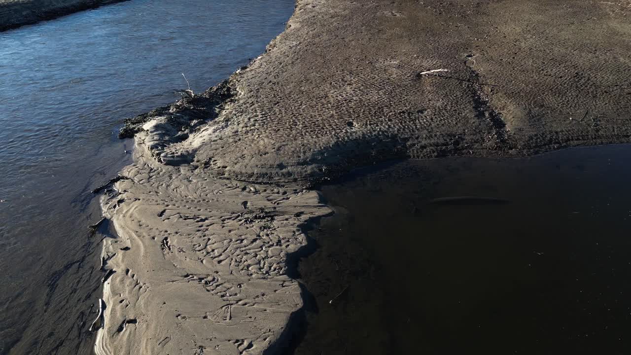 Drone flight over the river that is badly eroded