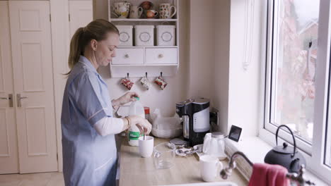 woman making coffee in kitchen