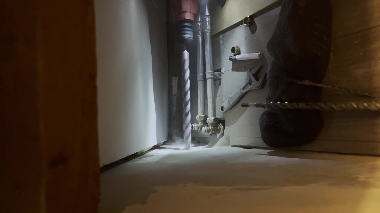 Drilling Concrete Floor With An Electric Drill. closeup