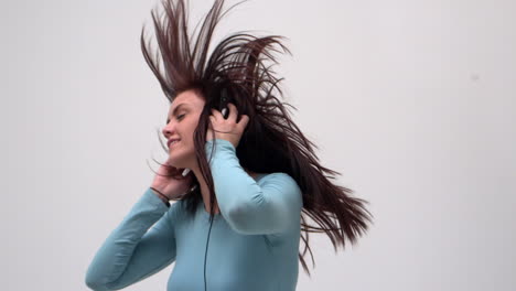 Happy-young-woman-dancing-while-listening-to-music