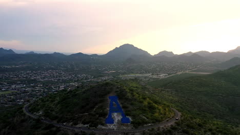 aerial view of a large 'a' on a mountainside at sunset in arizona