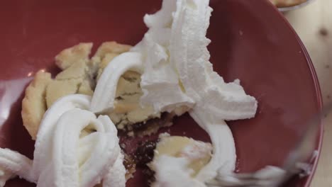 Fork-and-whipped-cream-topping-over-mince-pie-at-Christmas