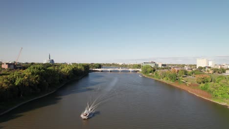 Water-Taxi-on-Winnipeg's-Red-River,-4K-drone-shot