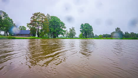 A-rainy-afternoon-on-a-lake-with-murky-water,-reflected-in-a-timelapse