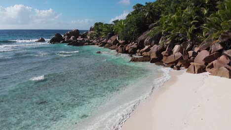 aerial view of the white beaches and turquoise waters at anse coco, petit anse and grand anse on la digue, an island of the seychelles