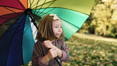 handheld view of running child with colorful umbrella