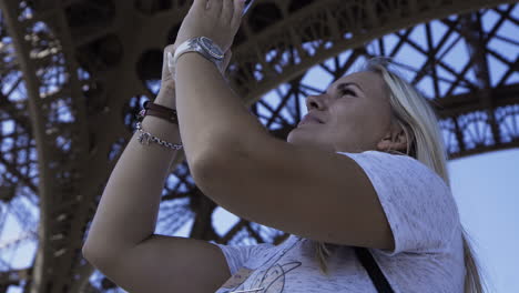 woman taking photo of the eiffel tower