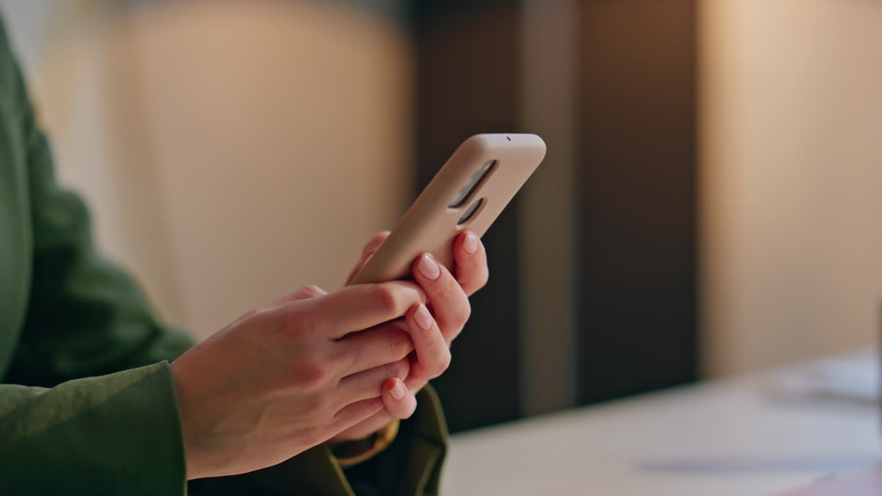 Employee hands typing message mobile phone at workplace closeup. Woman browsing