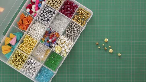 opening plastic jewelry organizer box with beads in compartments