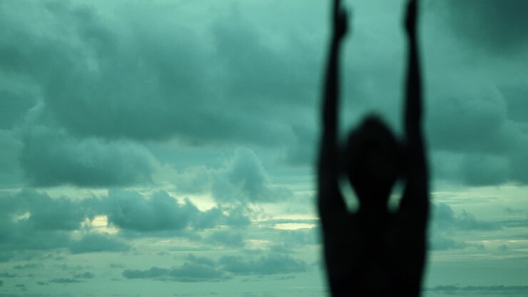 Silhouette of Person in Yoga Pose at Sunset