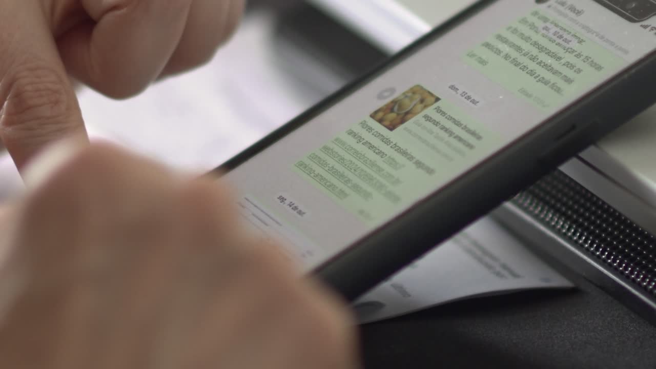 White woman using fingertips to scroll, text on mobile device, closeup